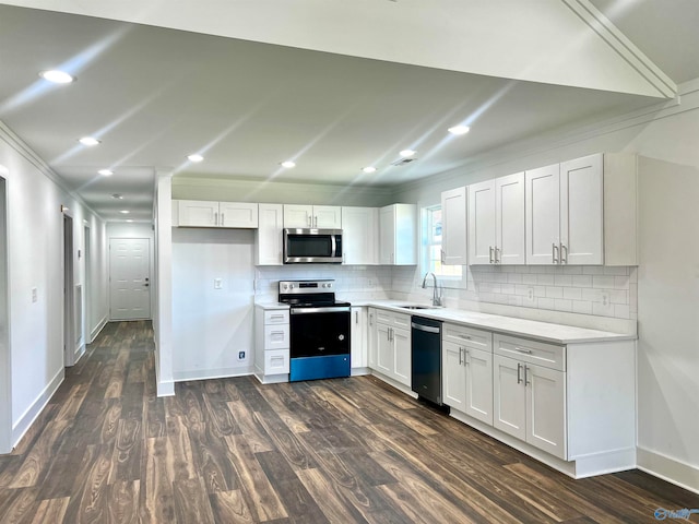 kitchen featuring dark hardwood / wood-style floors, sink, ornamental molding, appliances with stainless steel finishes, and white cabinetry