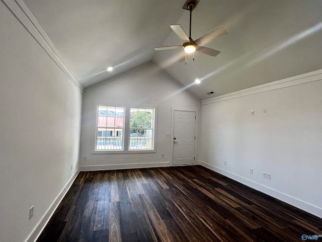 spare room with ceiling fan, lofted ceiling, crown molding, and dark hardwood / wood-style flooring