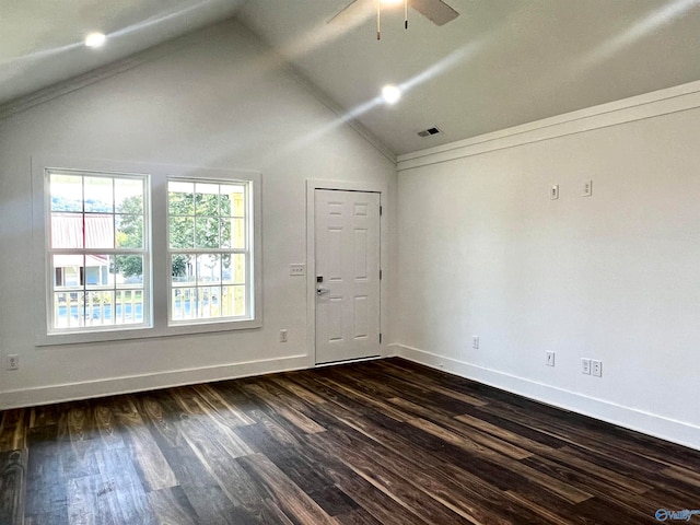 spare room featuring ceiling fan, dark wood-type flooring, crown molding, and vaulted ceiling