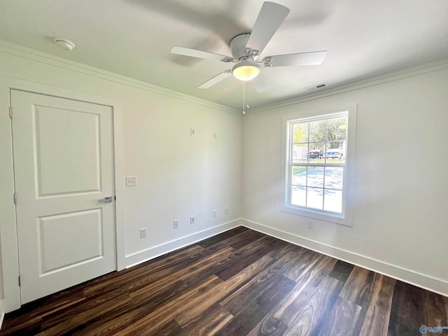 empty room featuring crown molding, dark hardwood / wood-style flooring, and ceiling fan