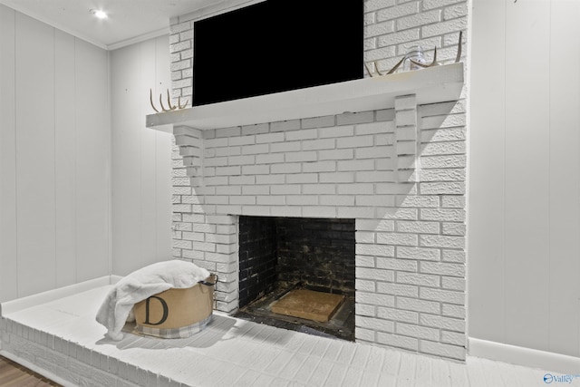 3374 Old Moulton Rd SW, Decatur, AL 35603 - detailed view of a fireplace, ornamental molding, a decorative wall, and wood finished floors