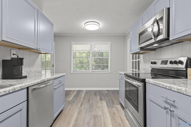 3374 Old Moulton Rd SW, Decatur, AL 35603 - kitchen with appliances with stainless steel finishes, light wood-style flooring, ornamental molding, gray cabinetry, and a textured ceiling