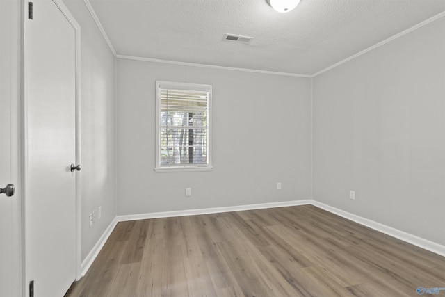 3374 Old Moulton Rd SW, Decatur, AL 35603 - spare room with a textured ceiling, crown molding, and wood finished floors