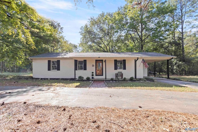 ranch-style house with a carport and a porch