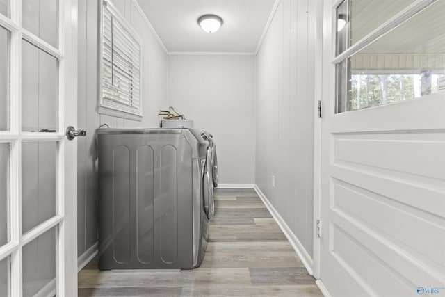 3374 Old Moulton Rd SW, Decatur, AL 35603 - washroom featuring washing machine and dryer, light wood finished floors, and ornamental molding