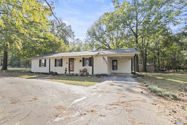 3374 Old Moulton Rd SW, Decatur, AL 35603 - view of front of home featuring driveway, a carport, and a porch