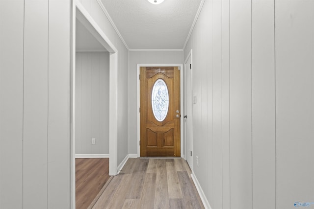 3374 Old Moulton Rd SW, Decatur, AL 35603 - foyer with light wood finished floors, ornamental molding, and a textured ceiling