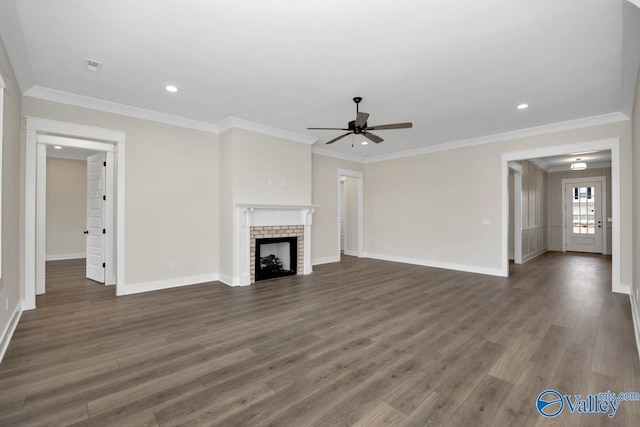 unfurnished living room with dark hardwood / wood-style flooring, ornamental molding, ceiling fan, and a fireplace