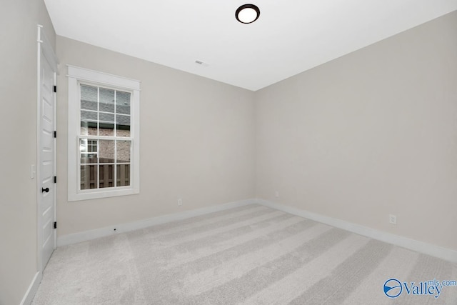 empty room featuring light colored carpet