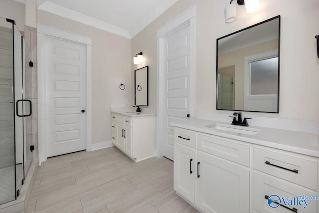 bathroom featuring crown molding, vanity, and a shower with door