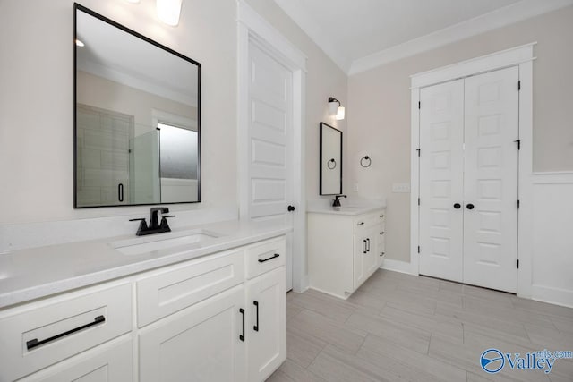 bathroom with an enclosed shower, vanity, and ornamental molding