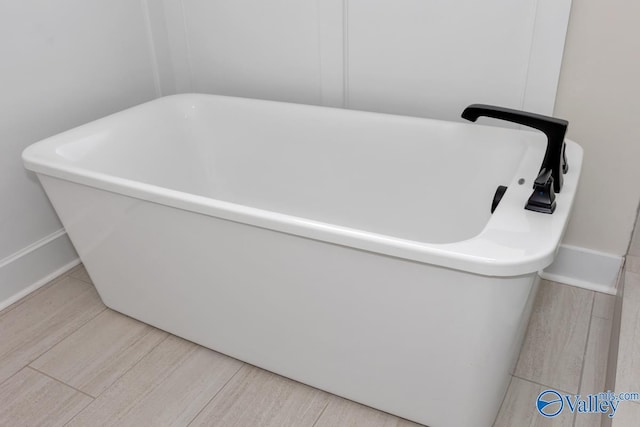 bathroom featuring a bath and wood-type flooring