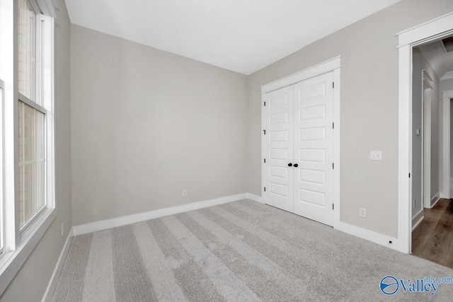 unfurnished bedroom featuring a closet and carpet