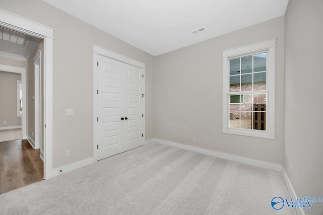 unfurnished bedroom featuring carpet and a closet