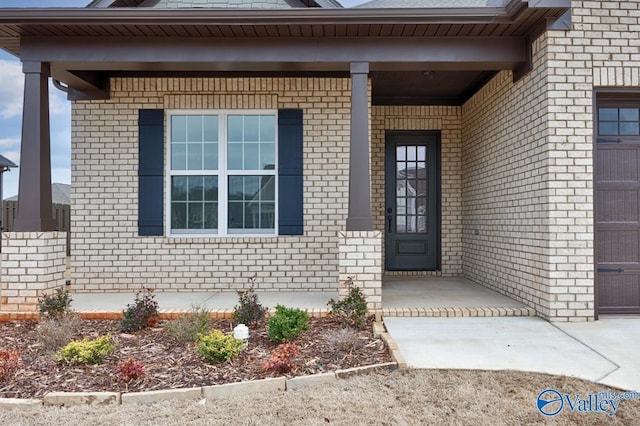 property entrance with a garage and covered porch