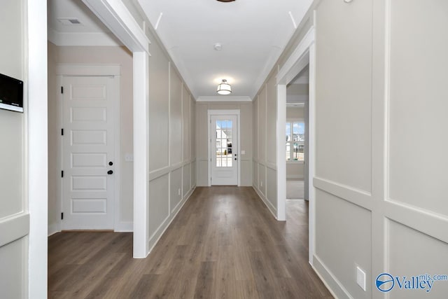 doorway to outside featuring hardwood / wood-style floors and ornamental molding