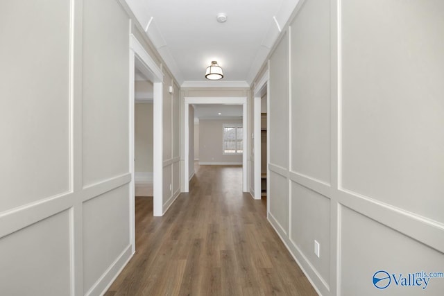 hall featuring crown molding and hardwood / wood-style flooring