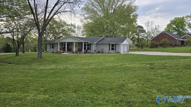 ranch-style home with a front yard, a porch, a garage, and driveway