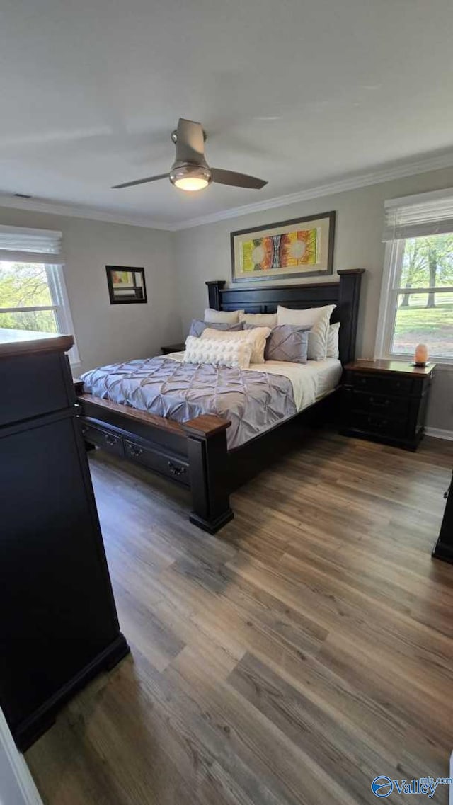 bedroom featuring ceiling fan, ornamental molding, and wood finished floors