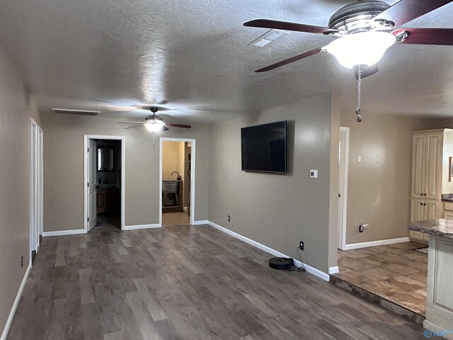 1020 County Road 92, Cedar Bluff, AL 35959 - unfurnished living room featuring a ceiling fan, wood finished floors, baseboards, and a textured ceiling