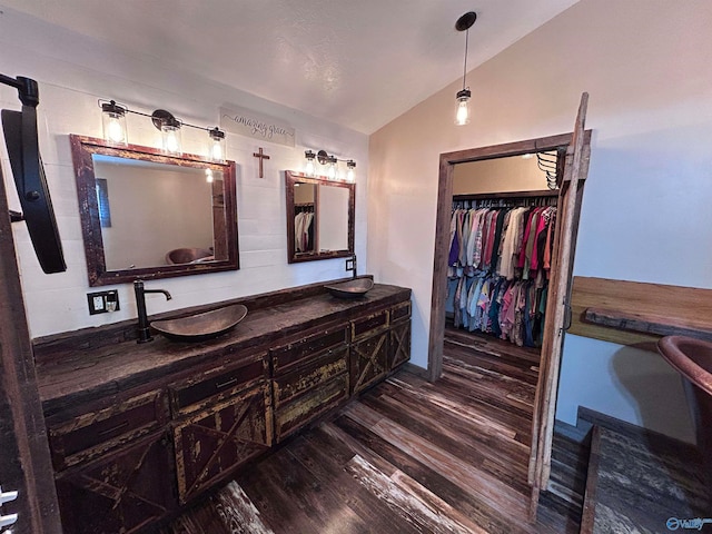 bathroom featuring hardwood / wood-style floors, vanity, and lofted ceiling