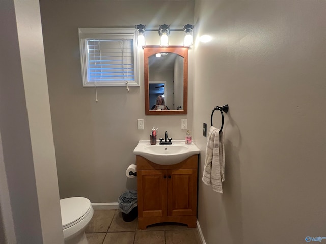 bathroom with tile patterned flooring, vanity, and toilet