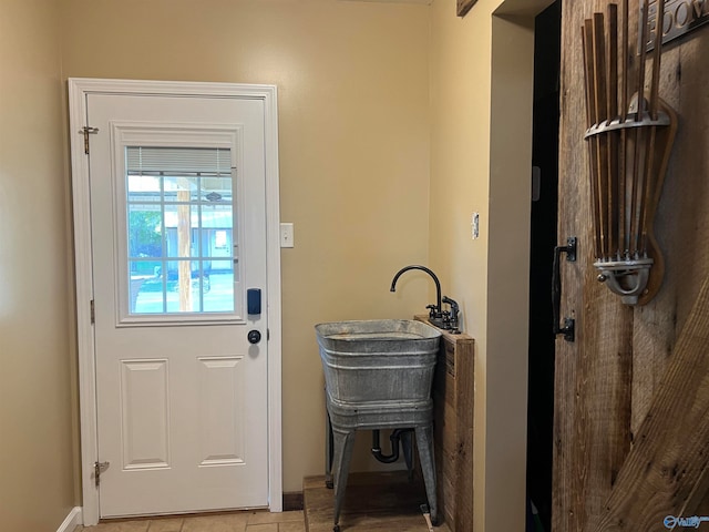 doorway with light tile patterned flooring