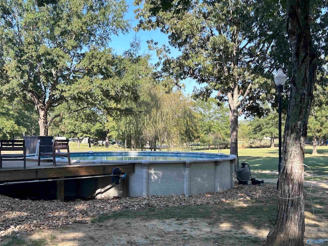 view of swimming pool with a wooden deck