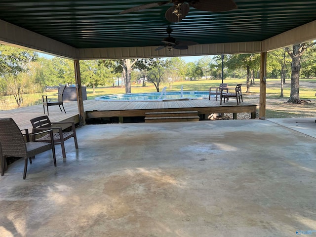 view of patio with ceiling fan and a deck