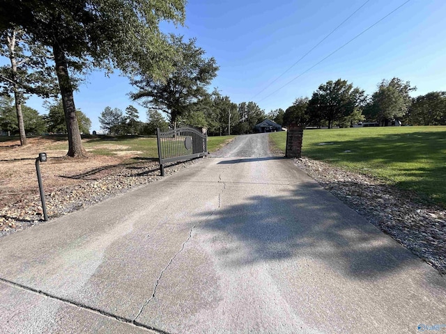 1020 County Road 92, Cedar Bluff, AL 35959 - view of concrete surface featuring a gated entry and view of scattered trees