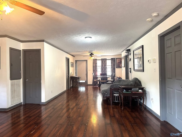 dining room with ceiling fan, dark wood-type flooring, a textured ceiling, and crown molding