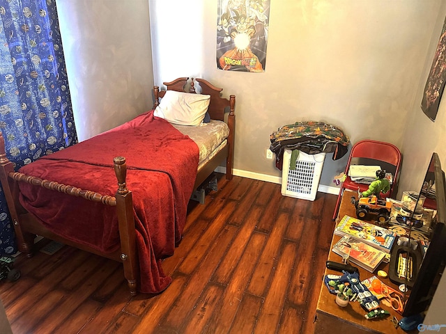 bedroom with dark hardwood / wood-style flooring