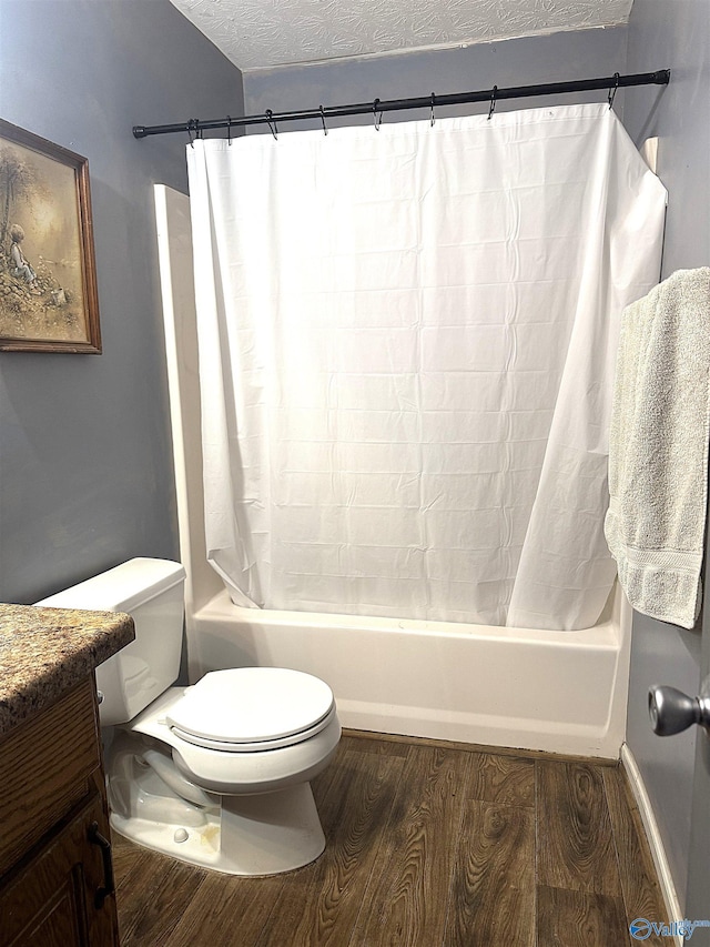 full bathroom with toilet, a textured ceiling, shower / bath combo, hardwood / wood-style floors, and vanity