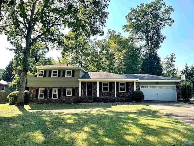 split level home with a garage and a front yard