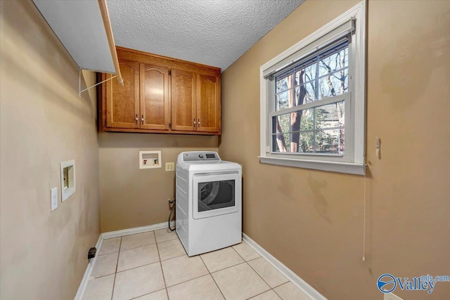 washroom featuring washer / dryer, light tile patterned floors, cabinet space, baseboards, and a textured ceiling