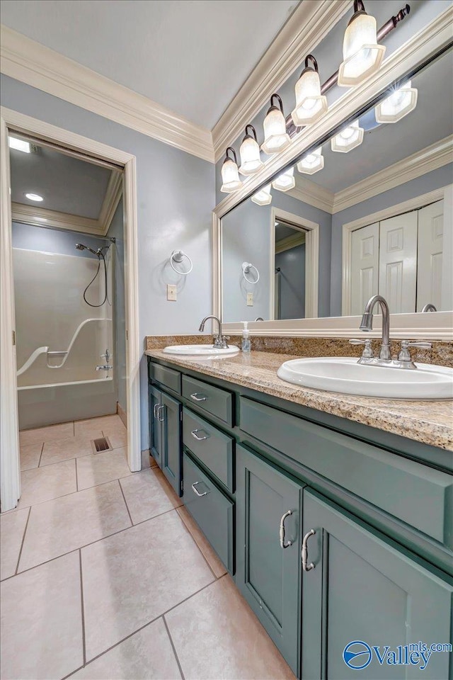 full bath with double vanity, tile patterned flooring, crown molding, and a sink