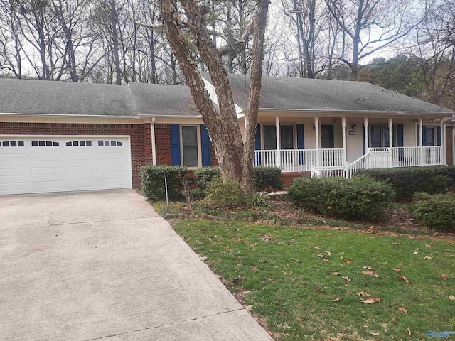 ranch-style house featuring an attached garage, covered porch, brick siding, driveway, and a front yard