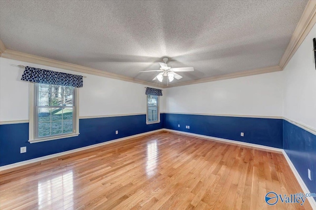 unfurnished room featuring ceiling fan, crown molding, a textured ceiling, and hardwood / wood-style flooring