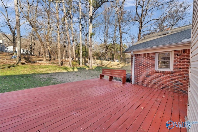 wooden deck featuring a lawn