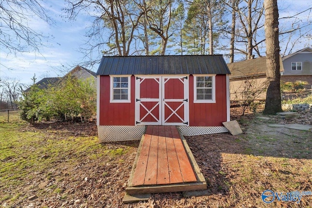 view of shed featuring fence