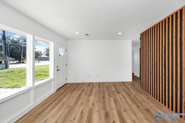 spare room featuring recessed lighting, baseboards, light wood-type flooring, and visible vents
