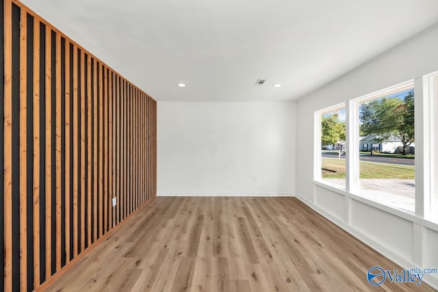 unfurnished room featuring recessed lighting, baseboards, visible vents, and light wood finished floors