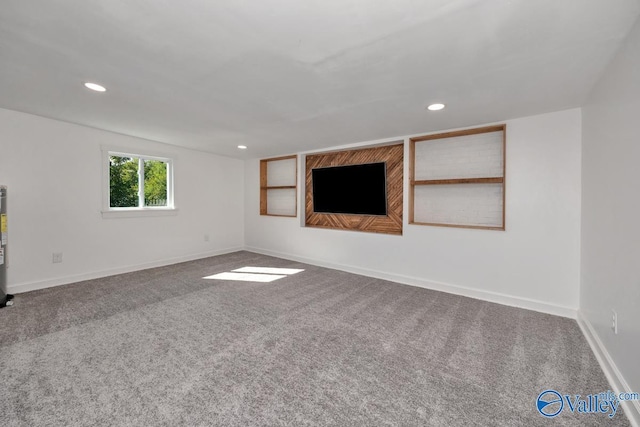 unfurnished living room featuring carpet floors, baseboards, and recessed lighting