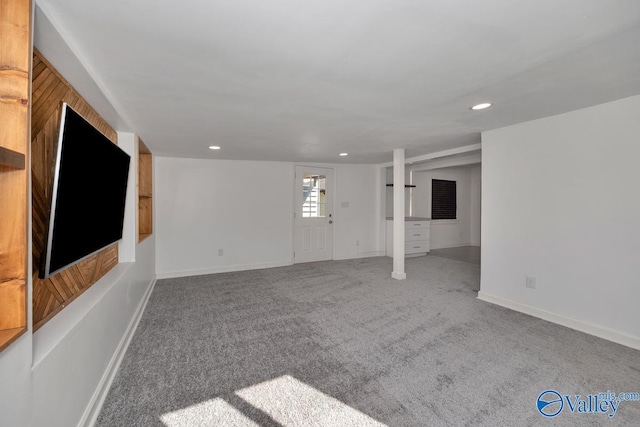 unfurnished living room with baseboards, carpet, and recessed lighting