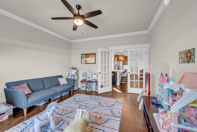 living room featuring sink, crown molding, dark wood-type flooring, and french doors