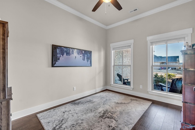 empty room with ornamental molding, dark hardwood / wood-style floors, and ceiling fan