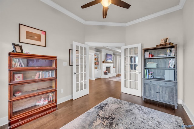 interior space featuring french doors, ceiling fan, ornamental molding, and dark wood-type flooring