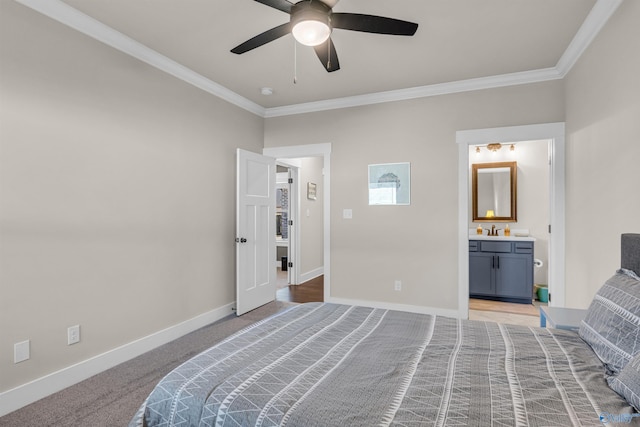 carpeted bedroom featuring connected bathroom, sink, crown molding, and ceiling fan