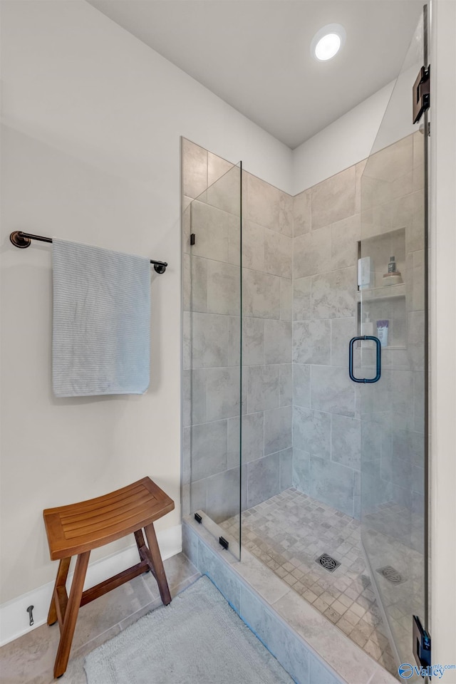 bathroom featuring an enclosed shower and tile patterned floors