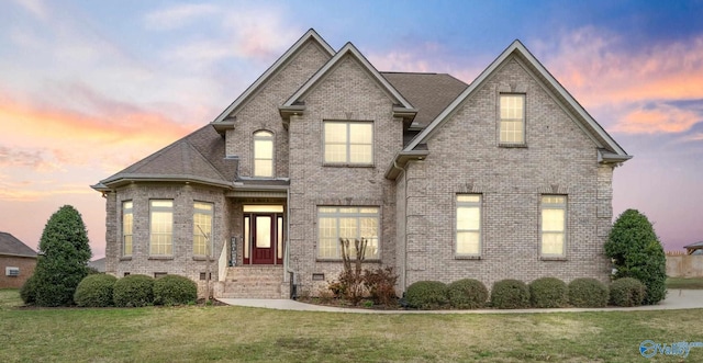 26409 Pepper Rd, Athens, AL 35613 - traditional-style house featuring brick siding, a shingled roof, and a yard